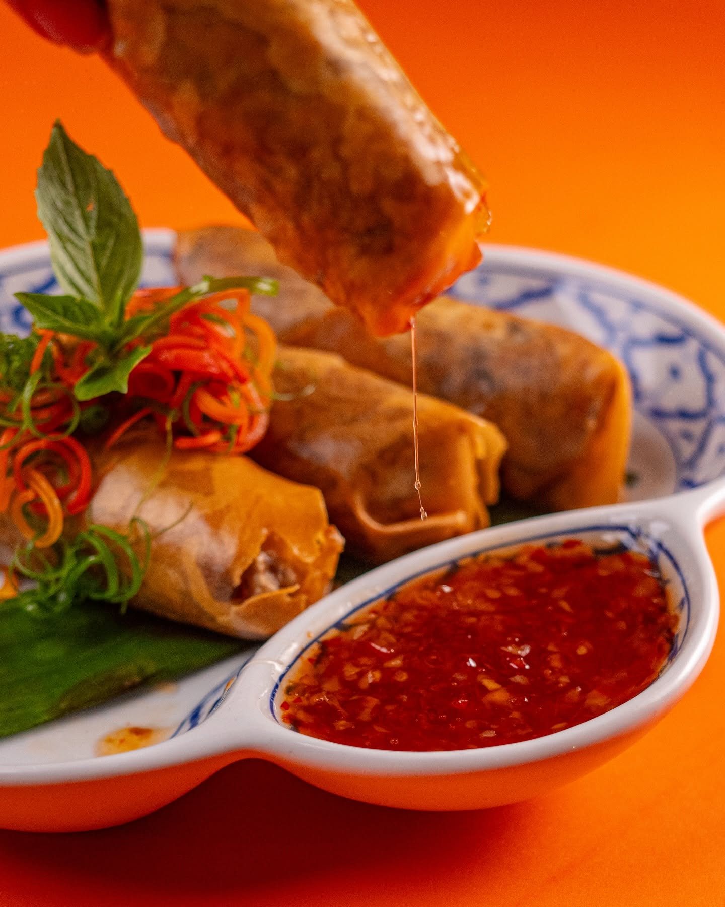 Deep-fried pork spring rolls with sweet chili dipping sauce