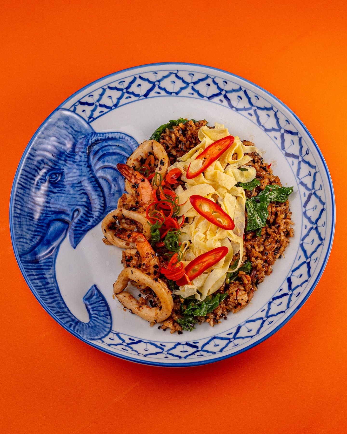 A Thai rice plate with omelette ribbons, minced pork and fresh chili